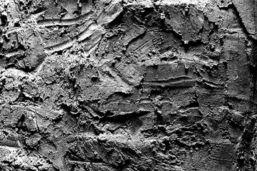 Close up texture of monochrome embossed plaster on the wall.
