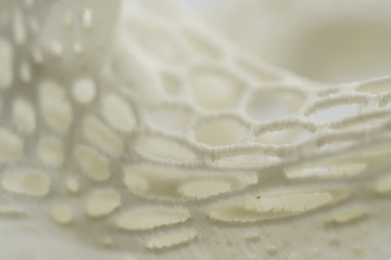 3D printed object close-up, mesh textured abstract background
