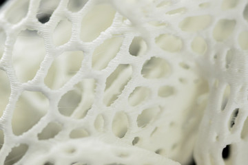 3D printed object close-up, mesh textured abstract background