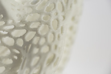 3D printed object close-up, mesh textured abstract background