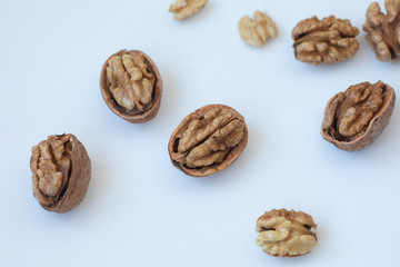 Walnuts kernels on dark desk with color background, Whole walnut in wood vintage bowl 