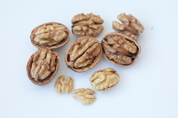 Walnuts kernels on dark desk with color background, Whole walnut in wood vintage bowl 