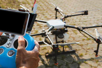 man controlling agriculture drone. remote controller