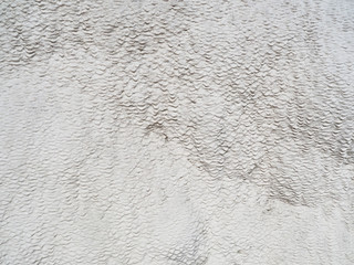 The background and texture of the carbonate mineral left by the flowing water at the cotton castle, Pamukkale, Turkey.