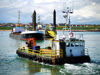 Port Construction Project vessels engaged in harbour reclamation work.