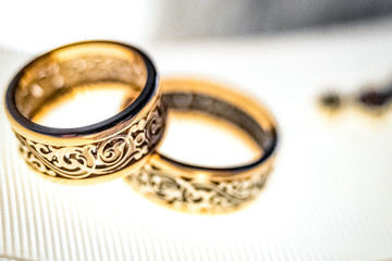 Wedding gold rings on white ribbon