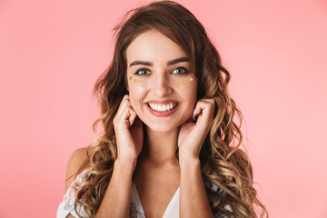 Fototapeta premium Image of pretty woman 20s wearing dress smiling and looking at you