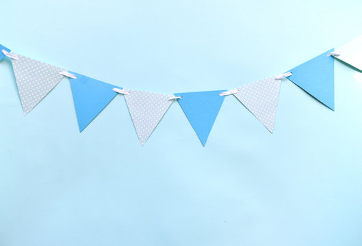 Festive Decor For A Children's Holiday To Smash The Cake Or A Birthday, Baby Shower Boy. Blue Triangular Flags On Blue Wall