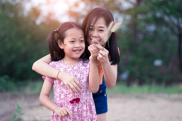 Asian little daughter have fun and happy  with her mother