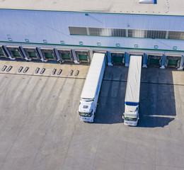 Truck while loading in a big distribution warehouse. Aerial View