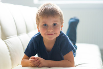 Naklejka premium Portrait of happy smiling boy. Attractive kid at home.