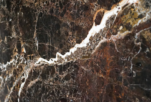 The texture of natural stone (granite, marble) on the floor of a large stoneware tile