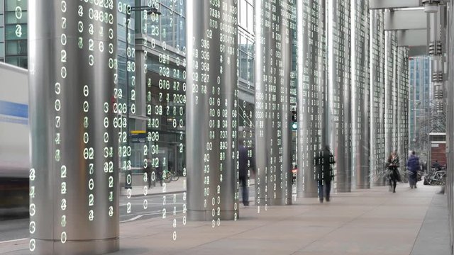 Business woman in a digital matrix environment.  Woman using a phone in a business district with a matrix background.