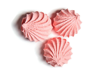 Three Meringue cookies. Meringues kisses in pink color isolated on white background