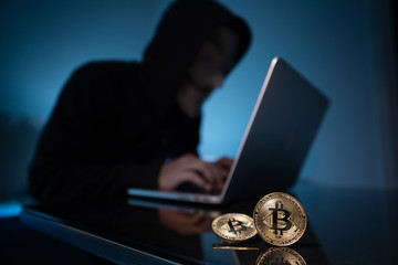 Hacker try to hack bitcoin blockchain system with laptop in dark room