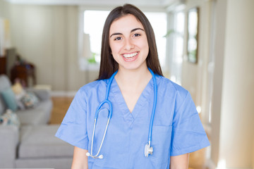 Beautiful young nurse woman wearing uniform and stethoscope at the clinic with a happy and cool smile on face. Lucky person.