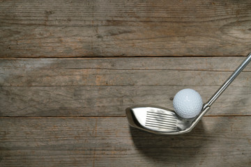 golf ball and golf club on wood table background, sport concpet