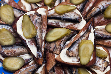 Sandwiches with sprats. Bread, mayonnaise, fish, pickles.