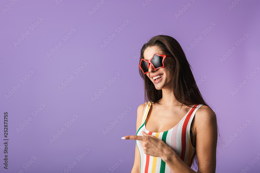 Canvas Prints Cheerful young girl wearing swimsuit standing