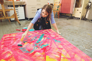 beautiful artist paint a huge canvas