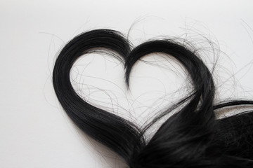 hair in the shape of a heart on a white background