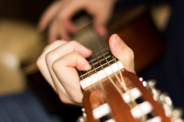 Fototapeta premium Classical guitar in the hands of a young guy.