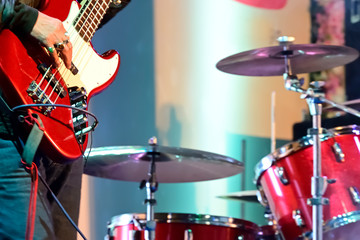 Close-up of guitarist playing guitar in live concert on stage. 