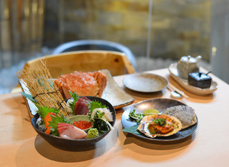 Mixed sliced fish sashimi on ice in bowl