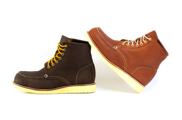 Menâ€™s brown boots isolated on a white background.