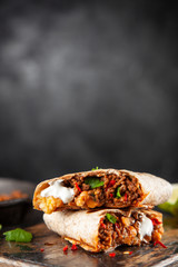 Mexican burrito with beef, beans and sour cream
