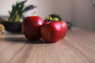 Red big apple on wooden background.