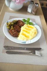 meatballs with mashed potatoes and pickled cucumbers are tasty and nutritious