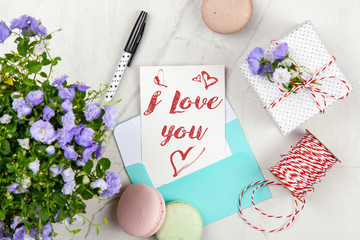 I Love You postcard on white marble table
