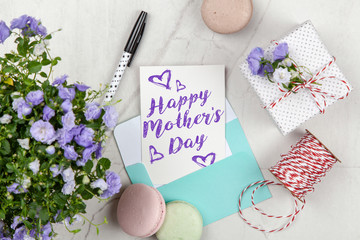Happy Mother's Day postcard on white marble table