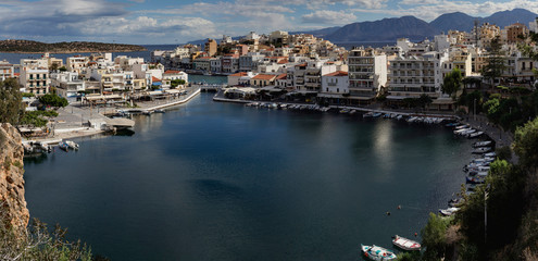 Fototapeta na wymiar View of the embankment of the city Saint Nicholas and a sea lake from high (island Crete, Greece)