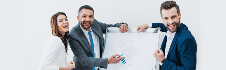 colleagues standing near stand with document and smiling isolated on white