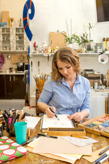 beautiful artist paints the portrait in the art Studio