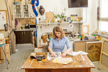 beautiful artist paints the portrait in the art Studio