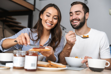 Happy multiethnic couple having breakfast