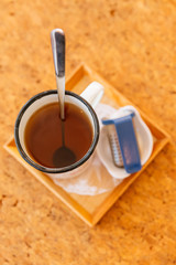 Top view of Afternoon Tea Set served hot water in gray pot with tin cup and tea infuser.