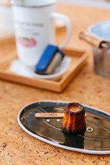 Fresh baked Canelés, A small French pastry flavored with rum and vanilla with a soft and tender custard center and a dark, thick caramelized crust.
