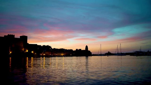 Beautiful small bay with old church of Our Lady of the Angels in the Collioure at late evening, France.