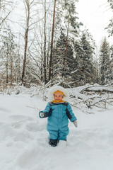 Fototapeta na wymiar A child for a walk in the winter. Family walks in nature in winter. Family walk. Winter forest. Snow park.