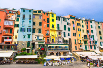 Row of colorful multicolored buildings houses and restaurants of Portovenere coastal town village in harbor of Ligurian sea, Riviera di Levante, National park Cinque Terre, La Spezia, Liguria, Italy