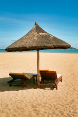 Two lonely loungers on the deserted beach of Hainan Island. 