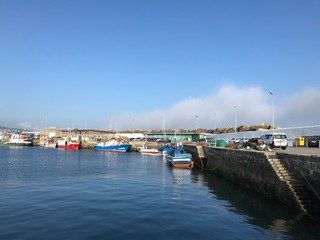 Fototapeta premium Some fishing boats docked at port during summer in Portonovo Spain