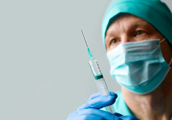 Man Doctor with syringe ready to make injection