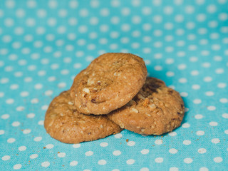 Oatmeal and raisin cookies on pastel blue polka dot background.