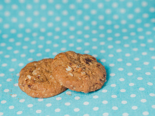 Oatmeal and raisin cookies on pastel blue polka dot background.