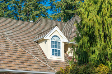 The top of the house or apartment building with nice window.